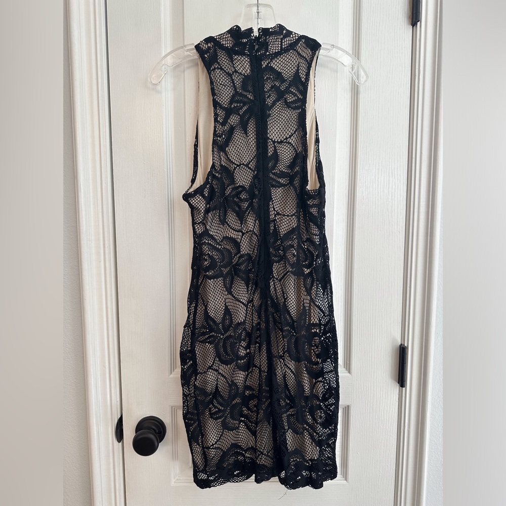 Form fitting nude cream slip dress with black lace overlay.